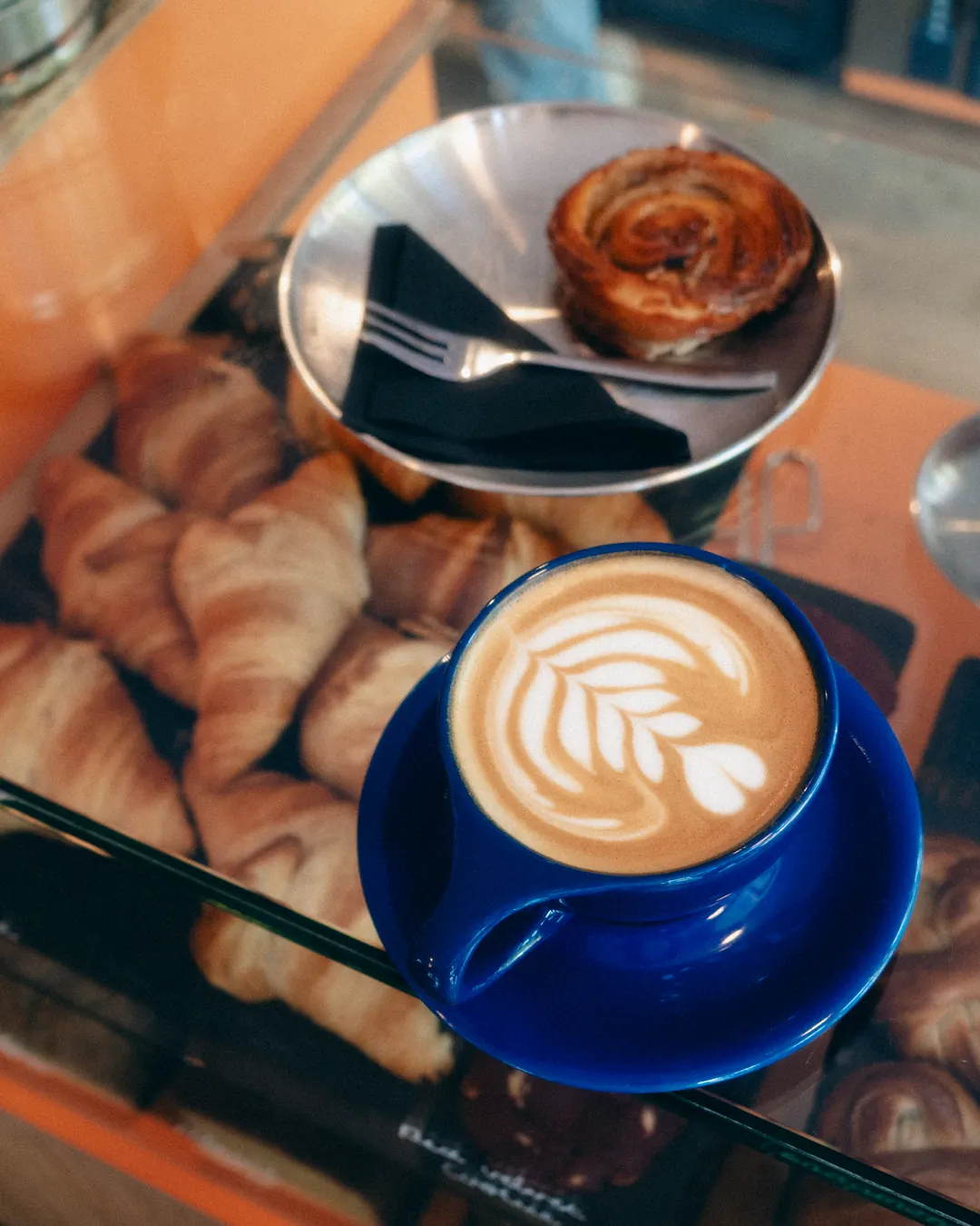 Cappuccino with latte art above the pastry counter